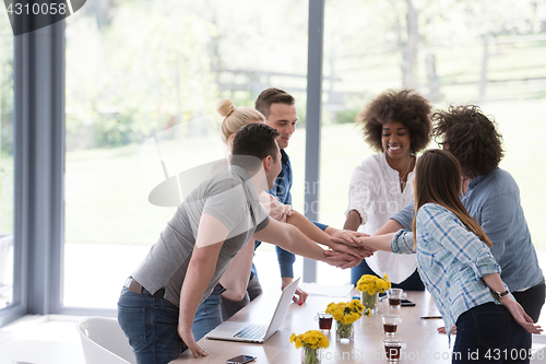 Image of multiethnic startup Group of young business people celebrating s