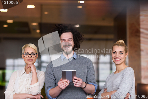 Image of group of Business People Working With Tablet in startup office