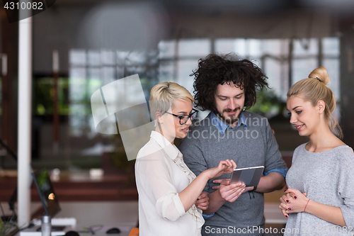 Image of group of Business People Working With Tablet in startup office