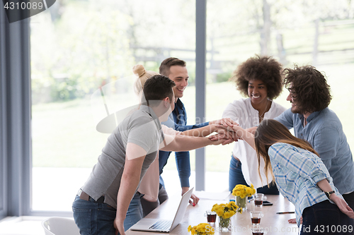 Image of multiethnic startup Group of young business people celebrating s