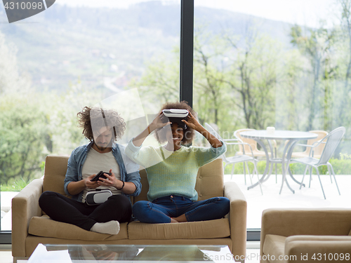 Image of Multiethnic Couple using virtual reality headset