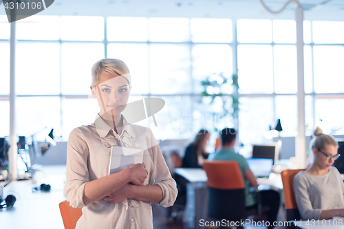 Image of woman working on digital tablet in night office