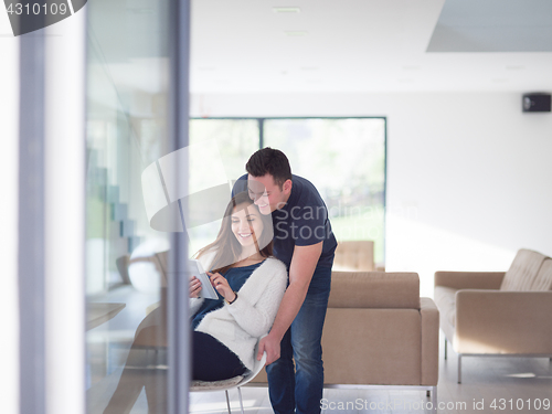 Image of couple using tablet at home