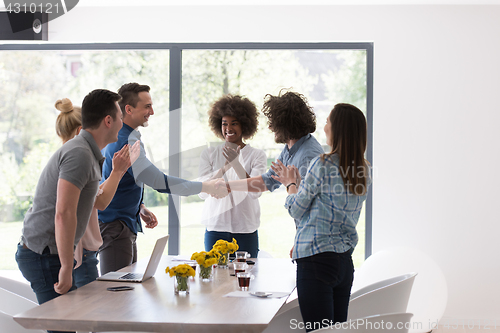 Image of multiethnic startup Group of young business people celebrating s