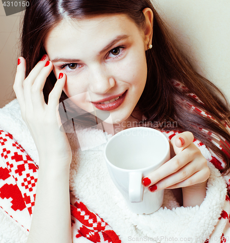 Image of young pretty brunette girl in Christmas ornament blanket getting warm on cold winter, freshness beauty concept 