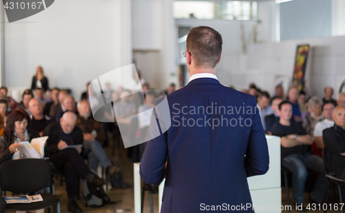 Image of Public speaker giving talk at Business Event.