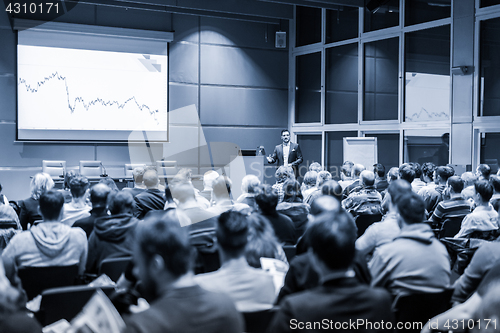 Image of Business speaker giving a talk at business conference event.