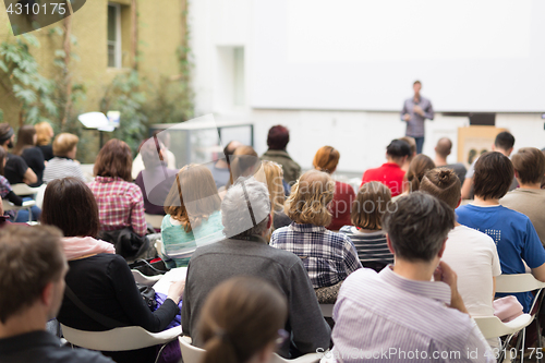 Image of Man giving presentation in lecture hall at university.