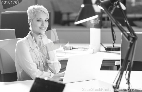 Image of Businesswoman using laptop at work