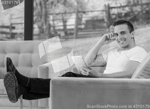 Image of Young boy lying on couch