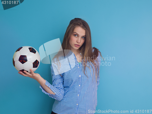 Image of young woman playing with a soccer ball