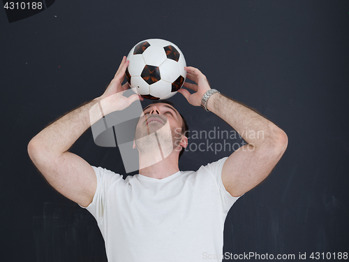 Image of man playing with soccer ball isolated over grey