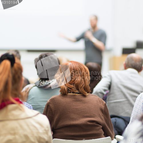 Image of Man giving presentation in lecture hall at university.
