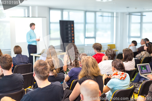 Image of Speaker giving presentation on business conference.