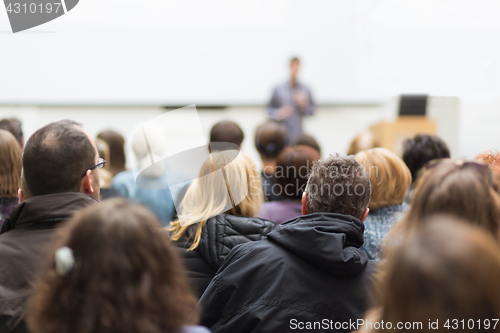 Image of Man giving presentation in lecture hall at university.