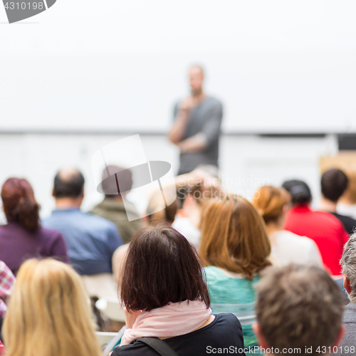 Image of Man giving presentation in lecture hall at university.