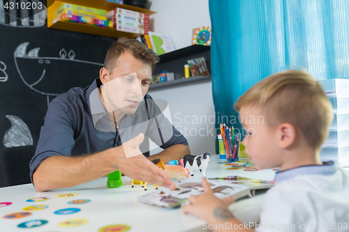 Image of Cute little boy at speechtherapist session.