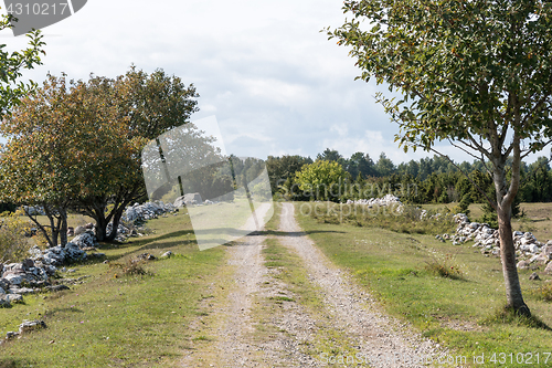 Image of Dirt road surrounded of stone walls