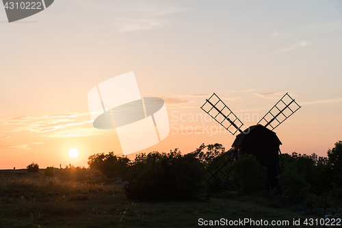 Image of Sunset by an old wooden windmill