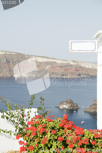 Image of volcanic island seaview with flowers geranium greek islands