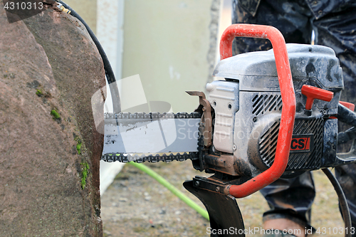 Image of Sawing Stone with ICS Chain Saw 