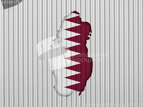 Image of Map and flag of Qatar on corrugated iron
