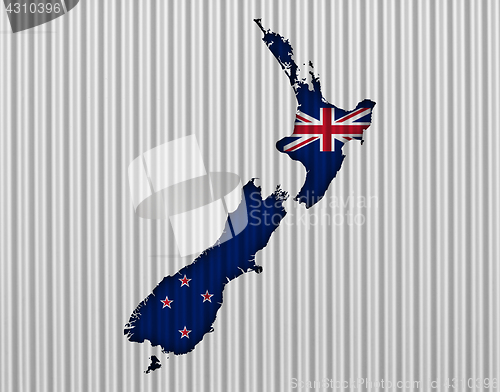 Image of Map and flag of New Zealand on corrugated iron,