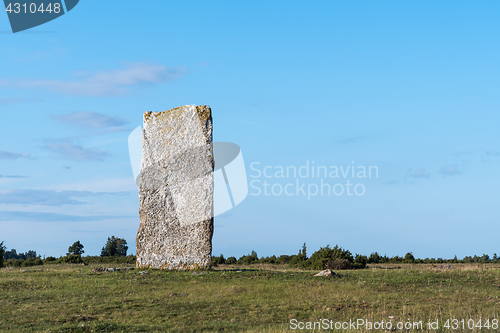 Image of Ancient standing stone in a plain landscape