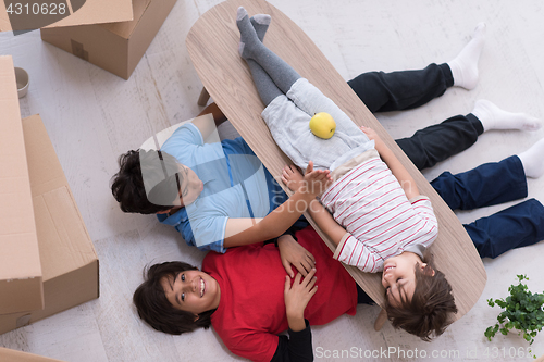 Image of boys with cardboard boxes around them top view