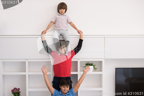 Image of young boys posing line up piggyback