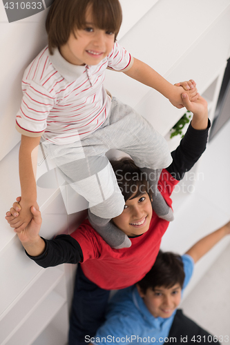 Image of young boys posing line up piggyback top view