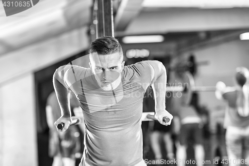 Image of man doing exercises parallel bars