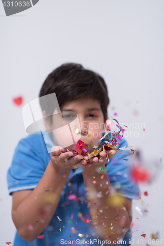 Image of kid blowing confetti