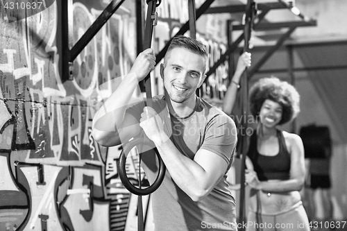 Image of Portrait of multiethnic couple  after workout at gym