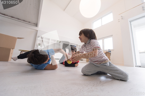 Image of boys having fun with an apple on the floor