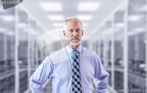 Image of Senior businessman in server room