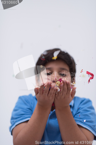 Image of kid blowing confetti