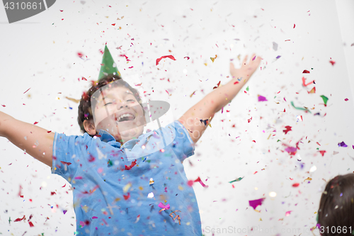 Image of kid blowing confetti