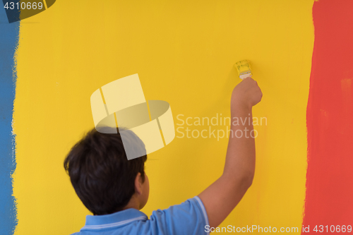 Image of Portrait of a happy young boy painter