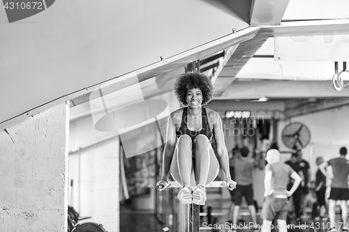 Image of black woman doing parallel bars Exercise