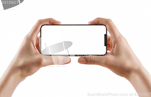 Image of hands holding black smart phone on white clipping path inside
