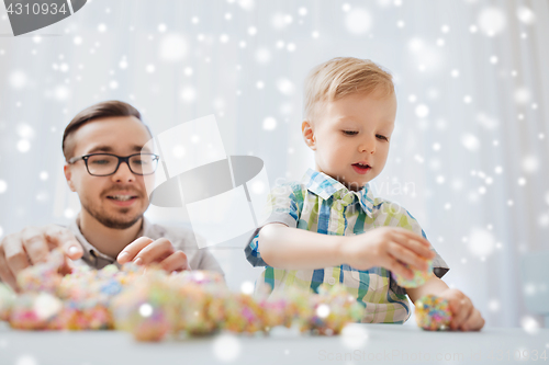 Image of father and son playing with ball clay at home