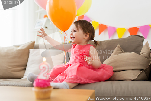 Image of happy baby girl on birthday party at home