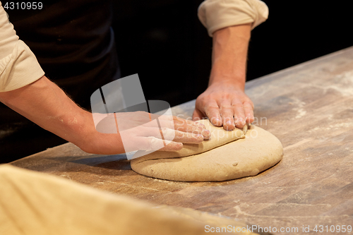 Image of chef or baker cooking dough at bakery