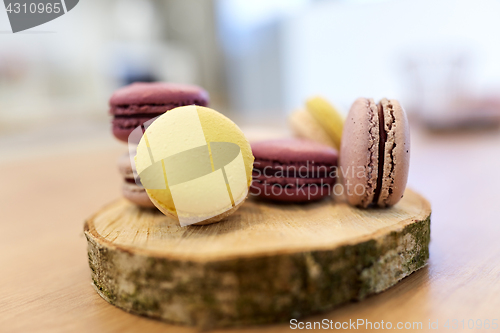 Image of different macarons on wooden stand