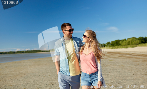 Image of happy couple hugging on summer beach