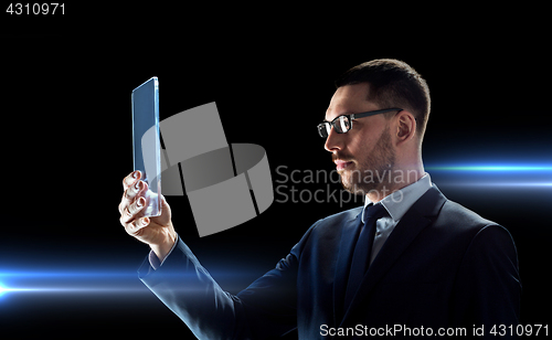 Image of businessman working with transparent tablet pc