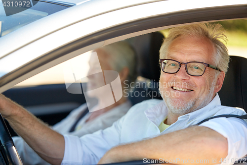 Image of happy senior couple driving in car