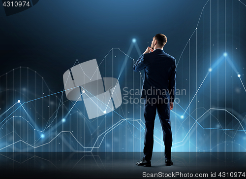 Image of businessman in suit from back with virtual graph