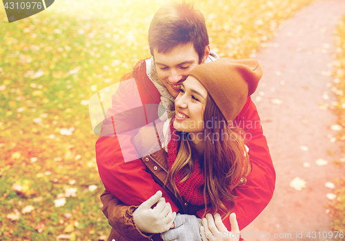 Image of happy young couple hugging in autumn park